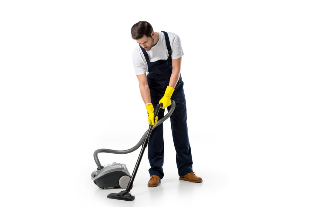 cleaner in uniform and rubber gloves with vacuum cleaner isolated on white